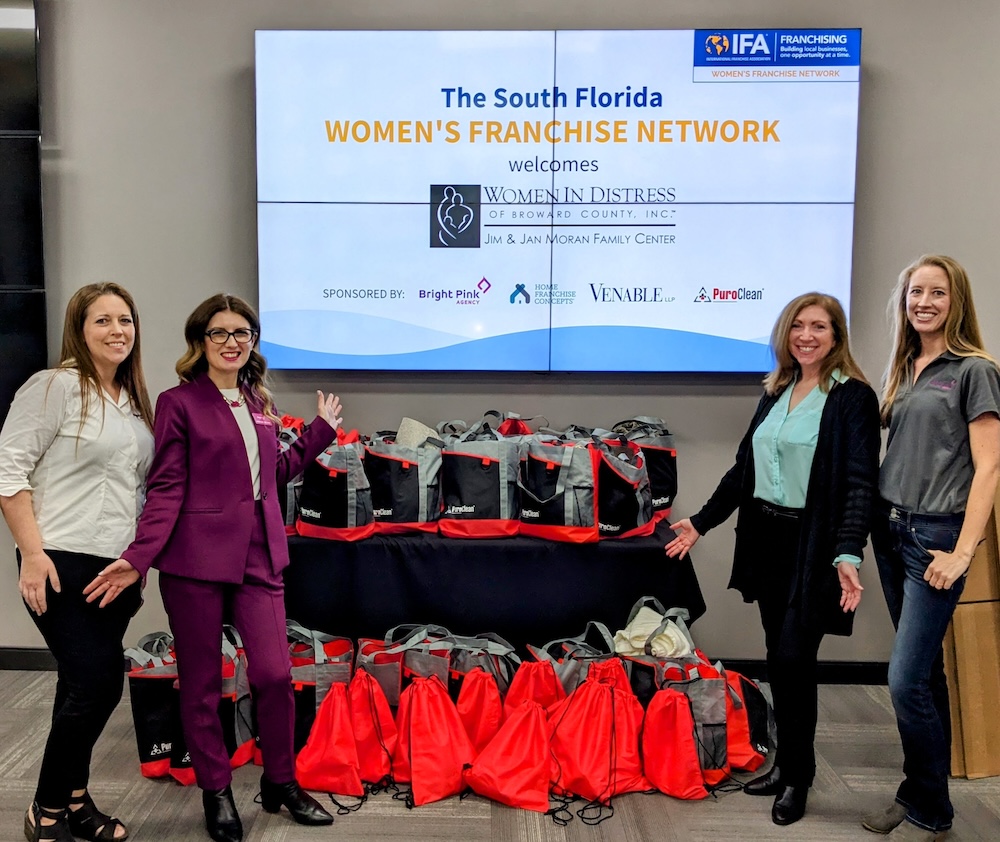 Bright Pink Agency team members with all the bags created for Women in Distress 