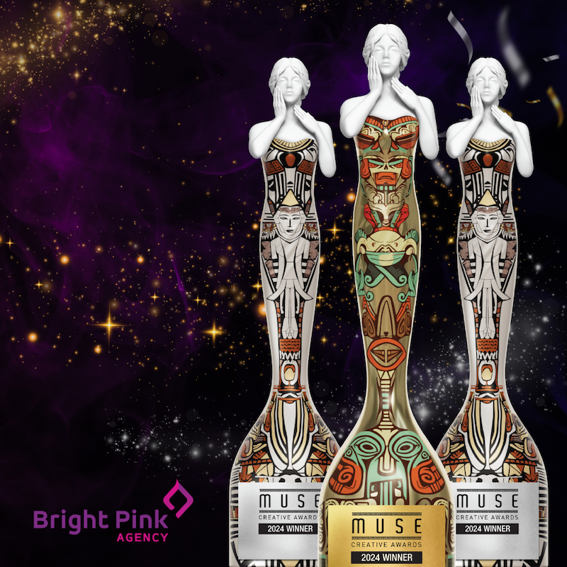 Starry background with 3 MUSE Creative Awards statuettes in Gold and Silver for the MUSE Design Awards earned by Bright Pink Agency.