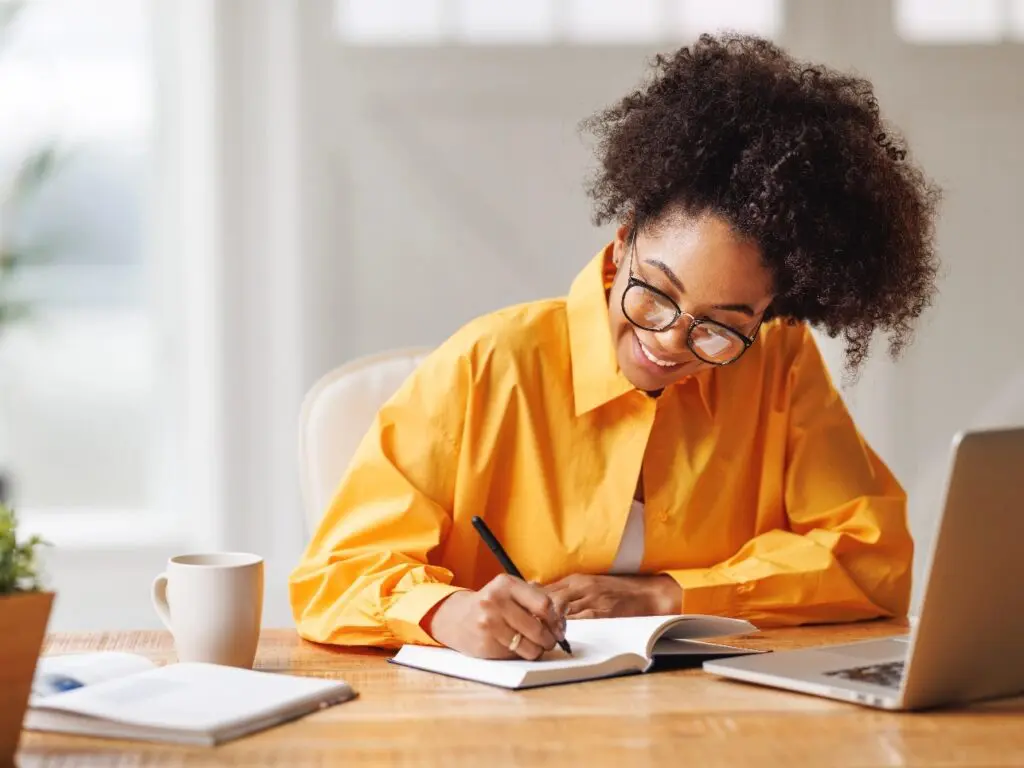 a woman writing in a book