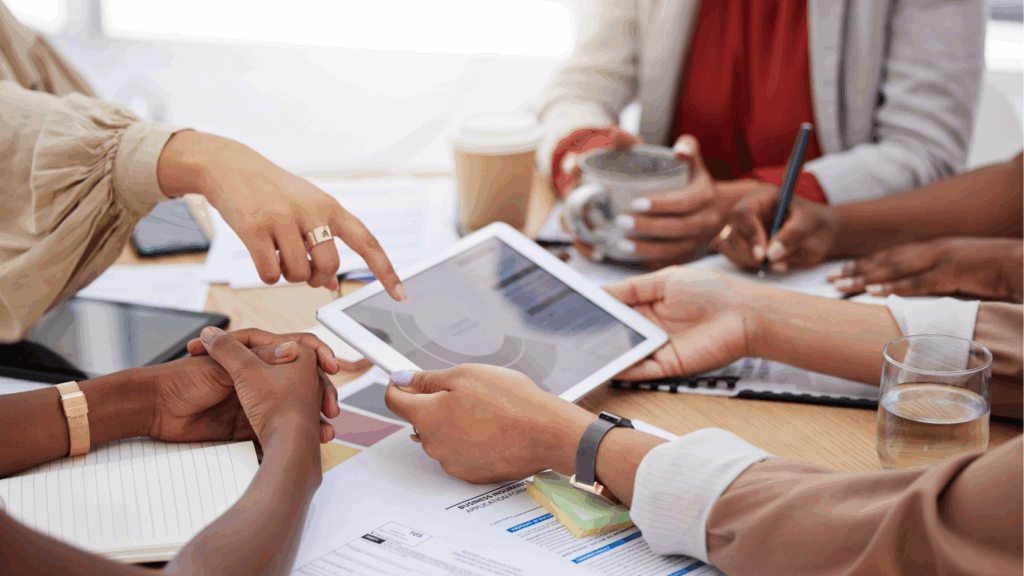 group of diverse people reviewing website analytics metrics to see how to benchmark website performance